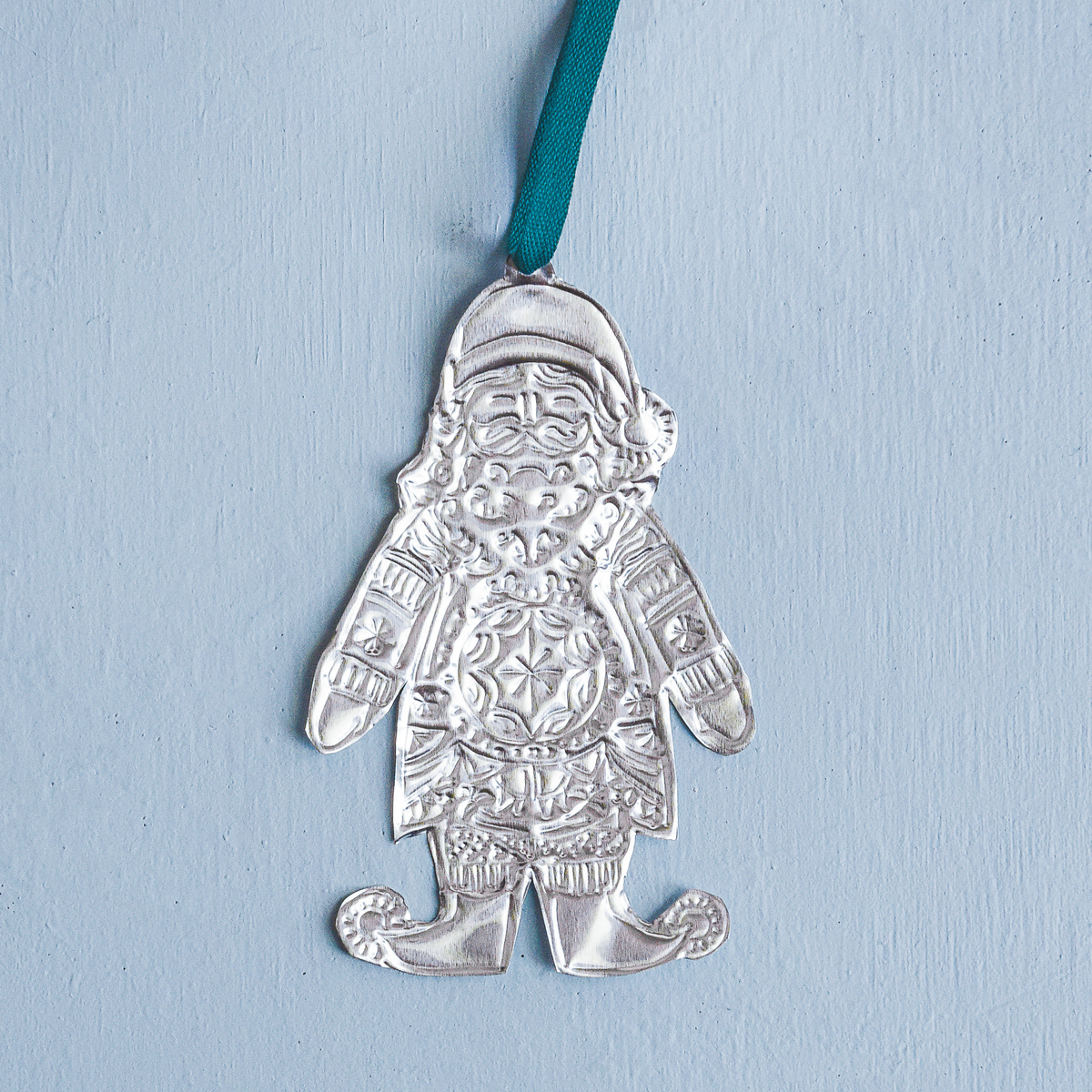Silver Santa Claus ornament on a blue background