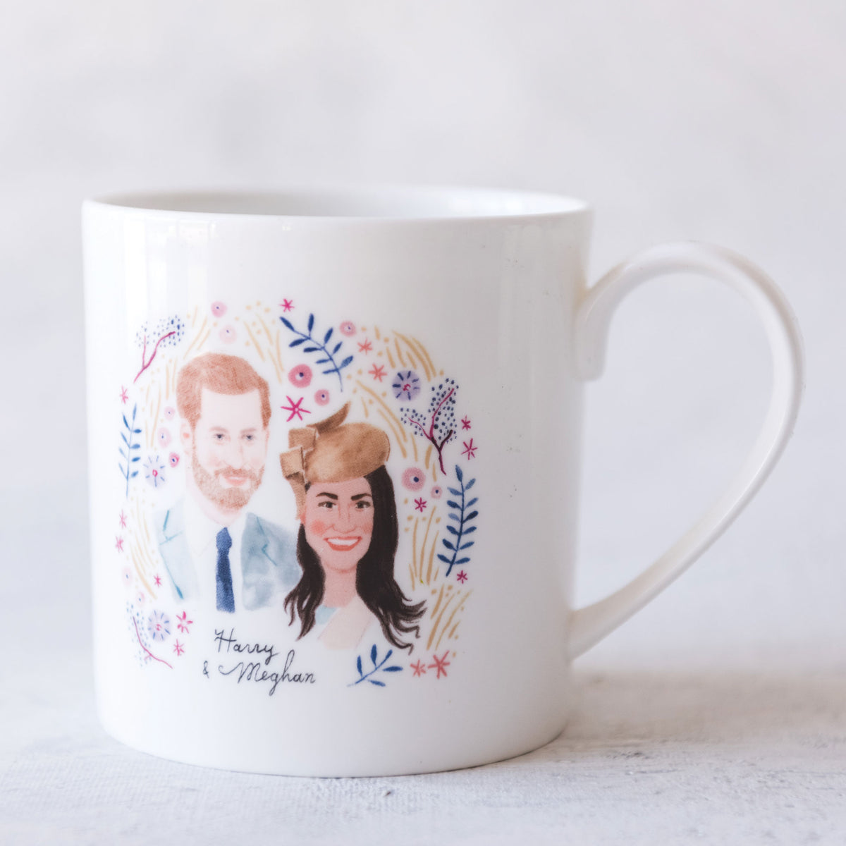 Illustration of Harry &amp; Meghan on a mug to celebrate their marriage.