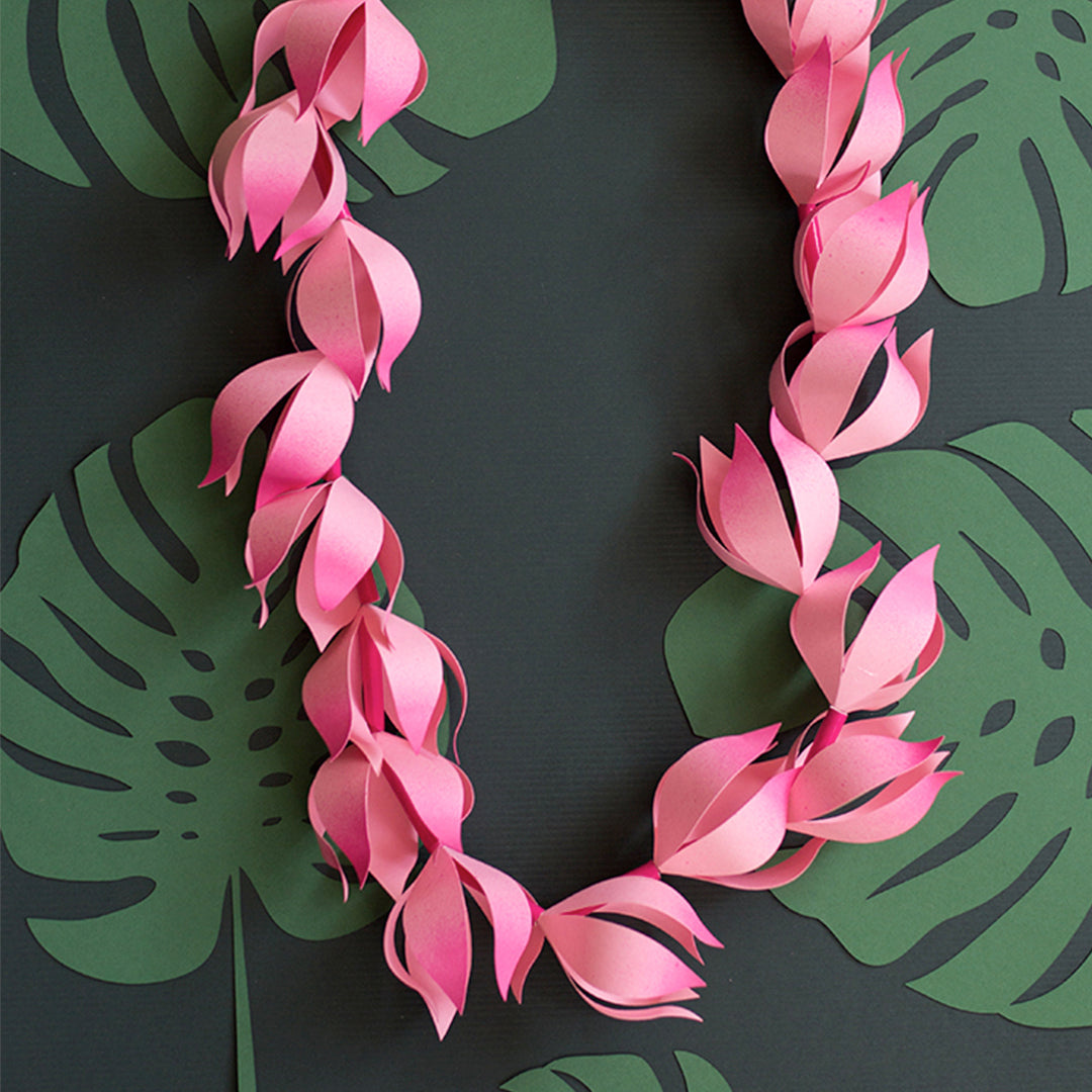 pink paper lei cut with Cricut machine or by hand. Tropical setting.