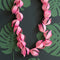 pink paper lei cut with Cricut machine or by hand. Tropical setting.